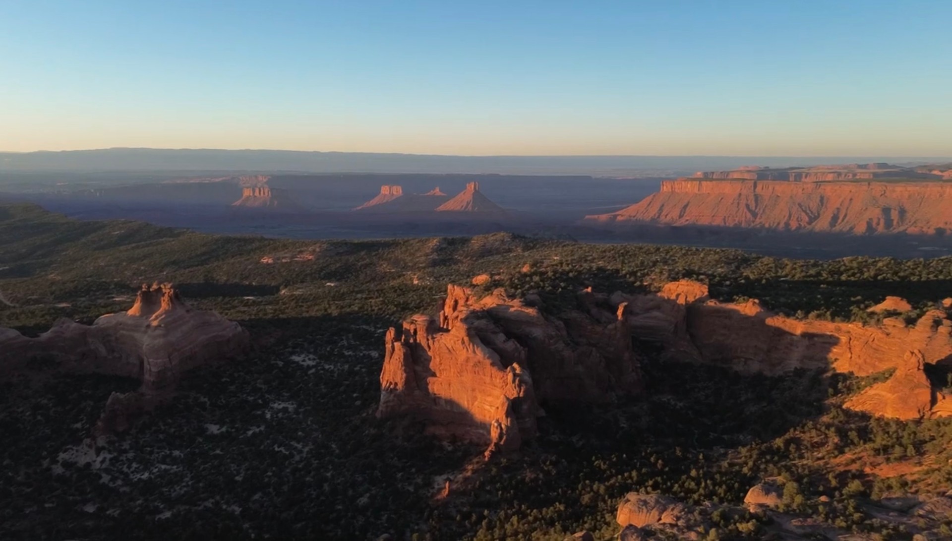 Canyon country at golden hour — buttes and mesas in the distance