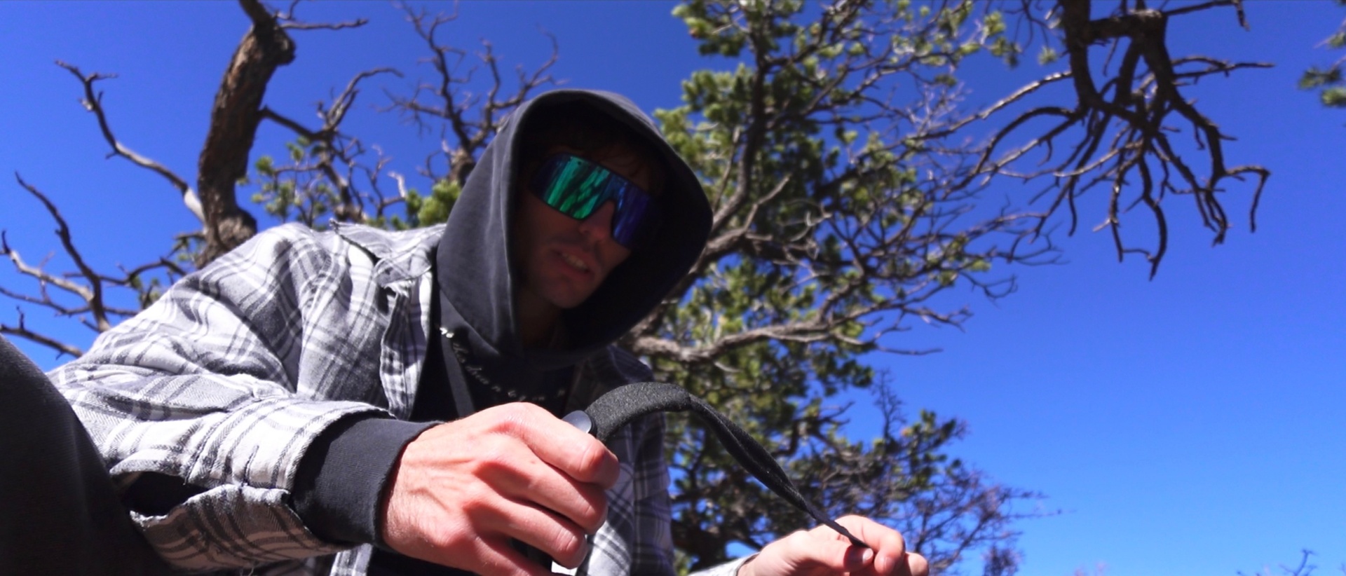 Prepping gear under a juniper tree